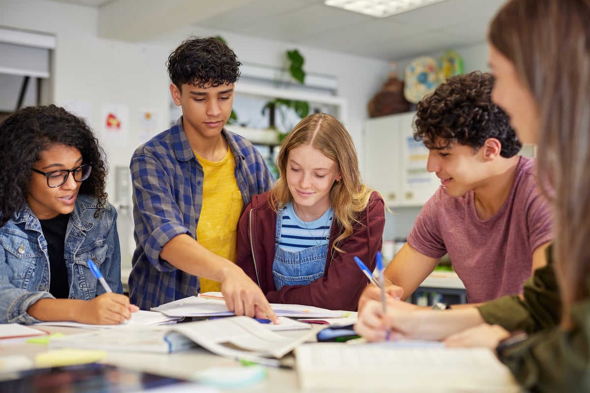 Diverse high school students collaborating during a study session in classroom